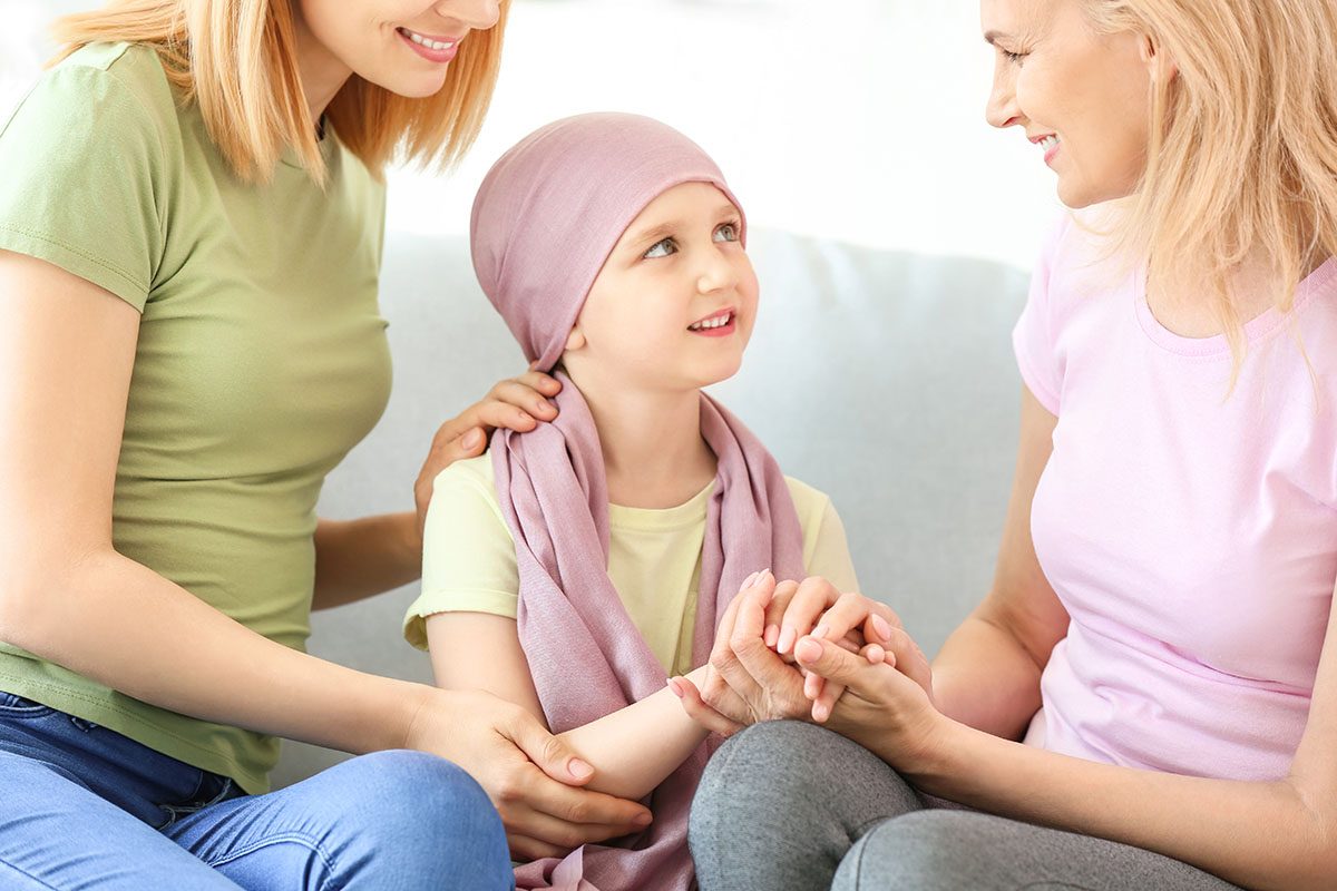 Little girl after chemotherapy with her family at home